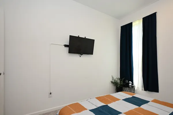 an empty room with a wooden floor and windows