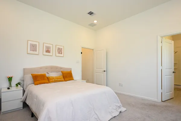 a bedroom with a bed and a painting on the wall