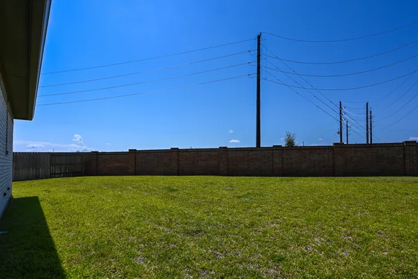 a view of a backyard with wooden fence