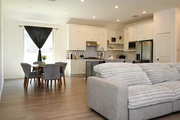 a large kitchen with kitchen island a sink table and chairs