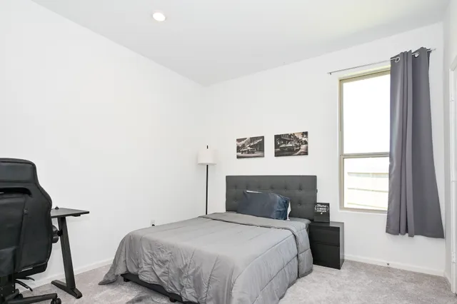 a living room with couches and kitchen view with wooden floor