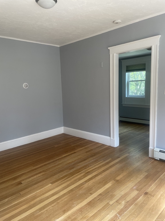 21 Arbor Lane, Unit 21 Dedham, MA 02026 - Photo 7 of 10 a view of a room with wooden floor and a sink