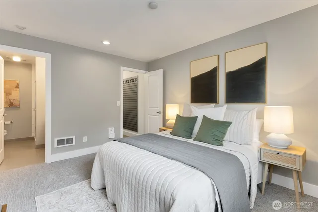 a bedroom with a bed and a flat tv screen