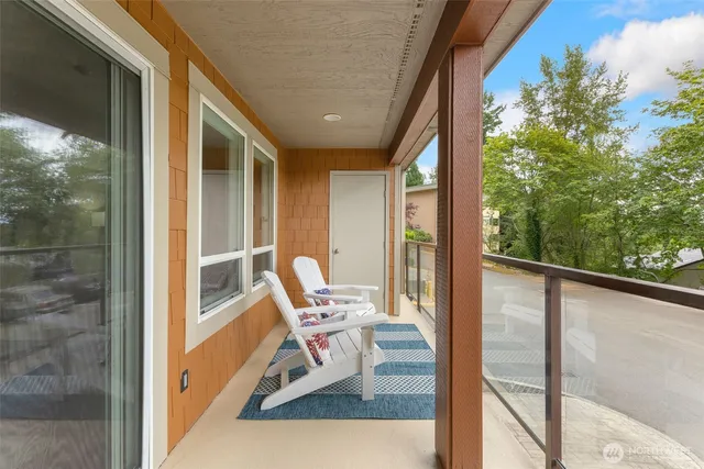 a view of a balcony with chair and table