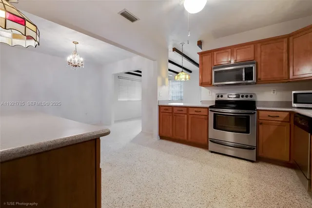 a kitchen that has a sink and a stove top oven