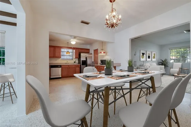 a view of a dining room with furniture and chandelier
