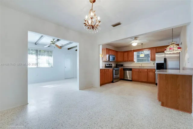 a view of a kitchen with a sink cabinet and a large window