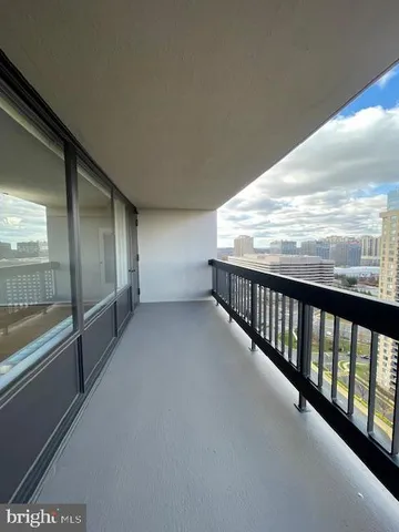 a view of balcony with floor to ceiling window