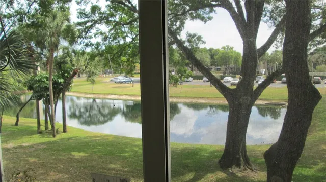 a view of a room with a large window and front view of a house
