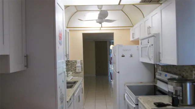 a kitchen with a refrigerator and cabinets