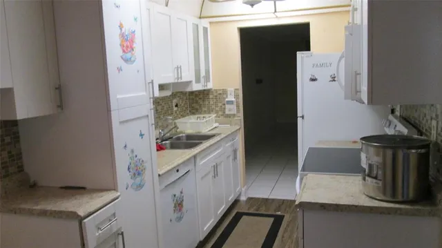 a kitchen with a sink and a stove