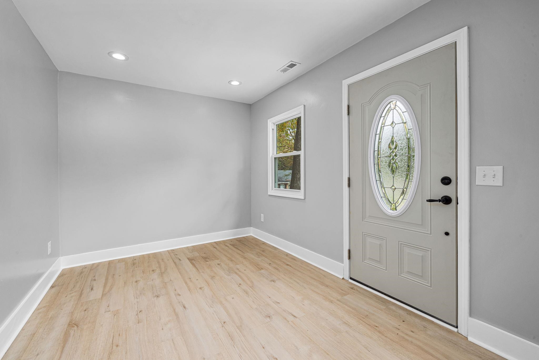 1200 Armstrong Circle Raleigh, NC 27610 - Photo 22 of 44 an empty room with wooden floor and windows
