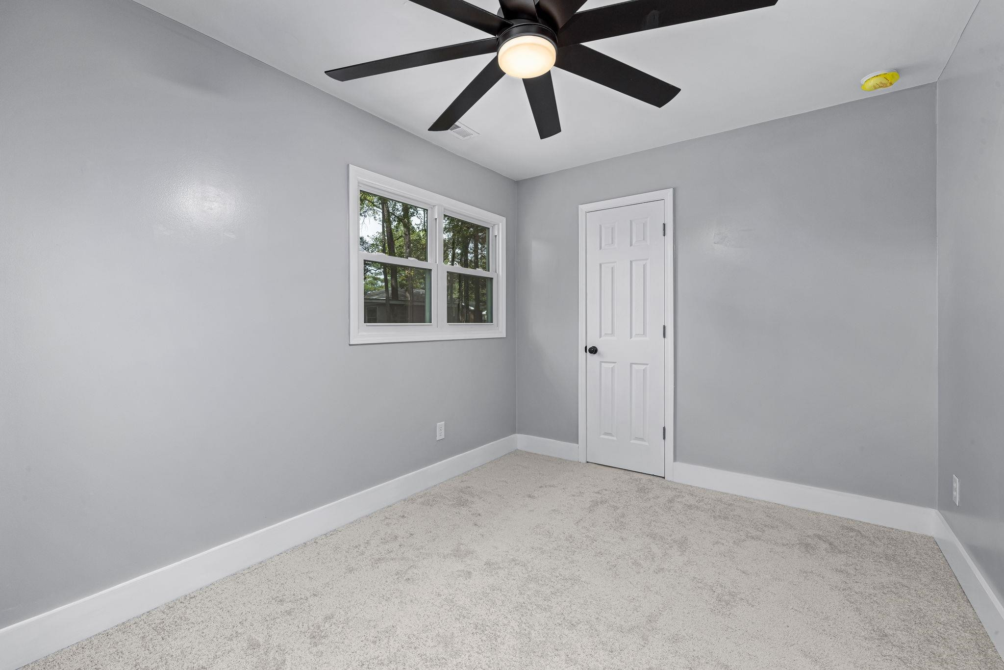 1200 Armstrong Circle Raleigh, NC 27610 - Photo 30 of 44 an empty room with windows and fan