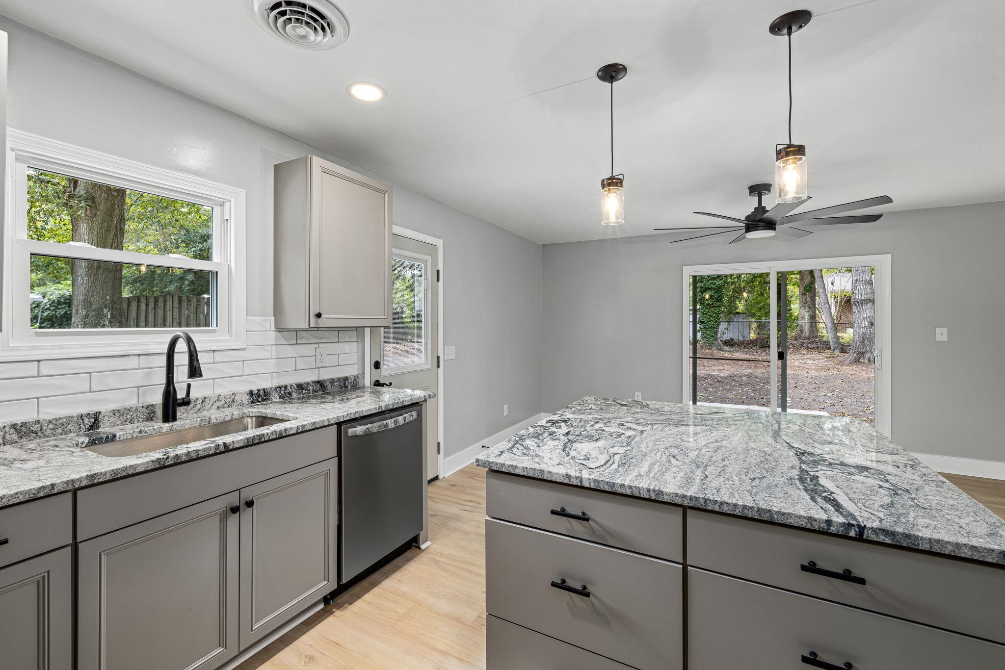 1200 Armstrong Circle Raleigh, NC 27610 - Photo 7 of 44 a kitchen with granite countertop kitchen island a sink appliances and a counter space