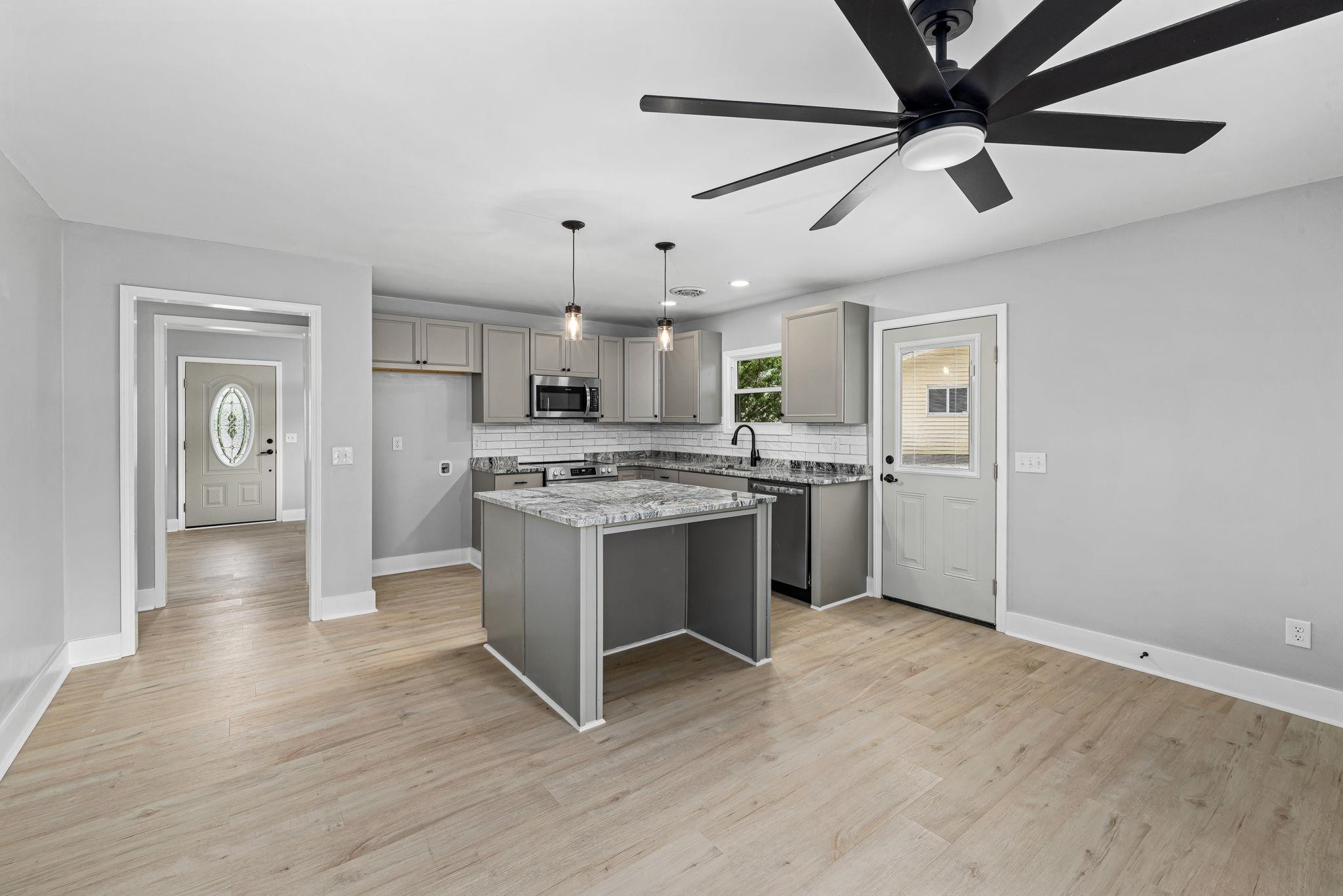 1200 Armstrong Circle Raleigh, NC 27610 - Photo 9 of 44 a kitchen with a refrigerator a sink and white cabinets