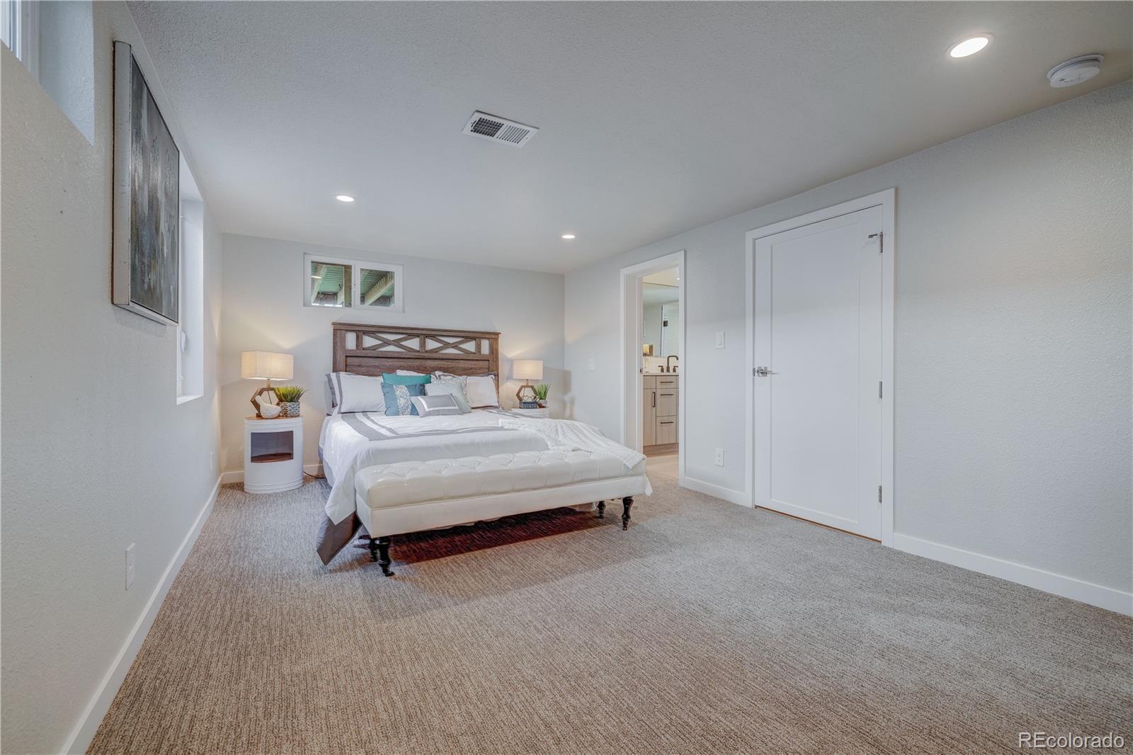 2932 Chase Street Wheat Ridge, CO 80214 - Photo 20 of 30 a bedroom with a bed and a night stand