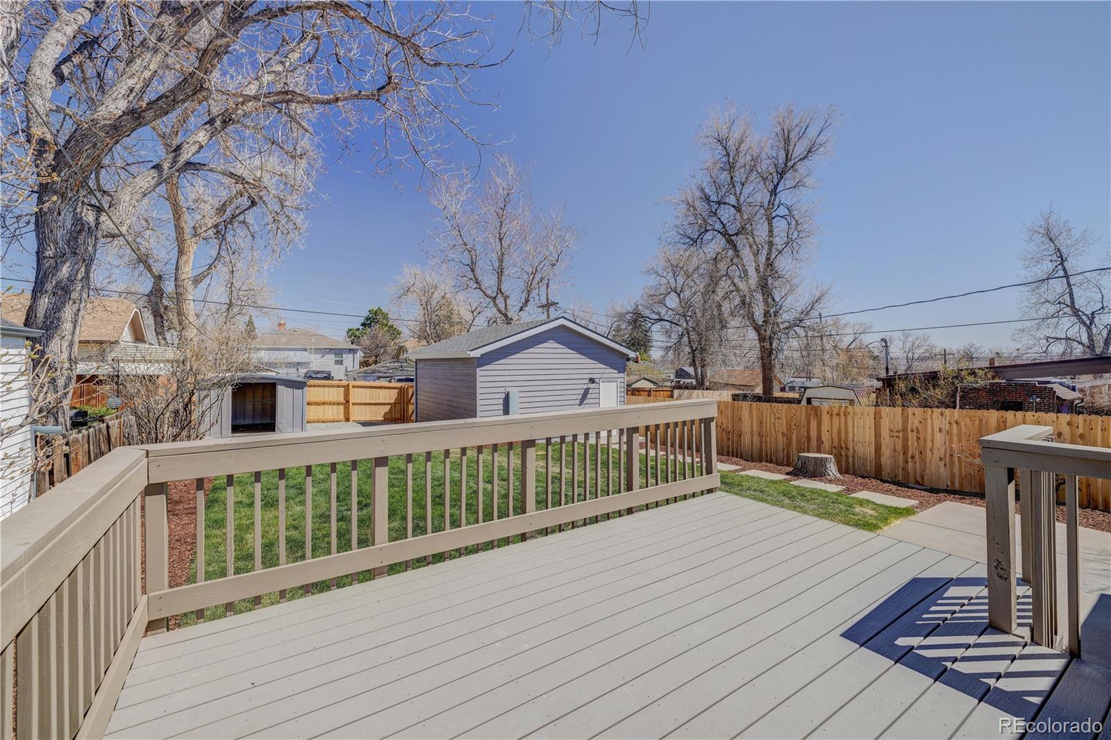 2932 Chase Street Wheat Ridge, CO 80214 - Photo 24 of 30 a view of a deck with wooden floor and fence with a barbeque