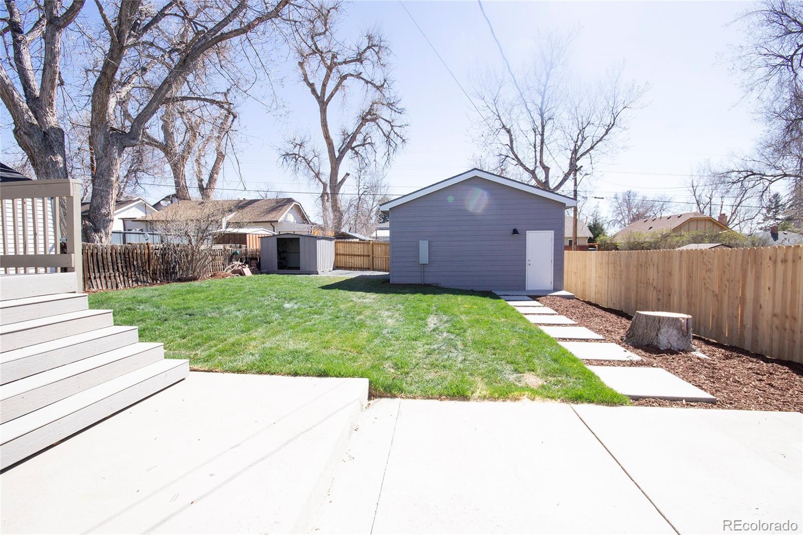 2932 Chase Street Wheat Ridge, CO 80214 - Photo 26 of 30 a view of a yard with a large tree