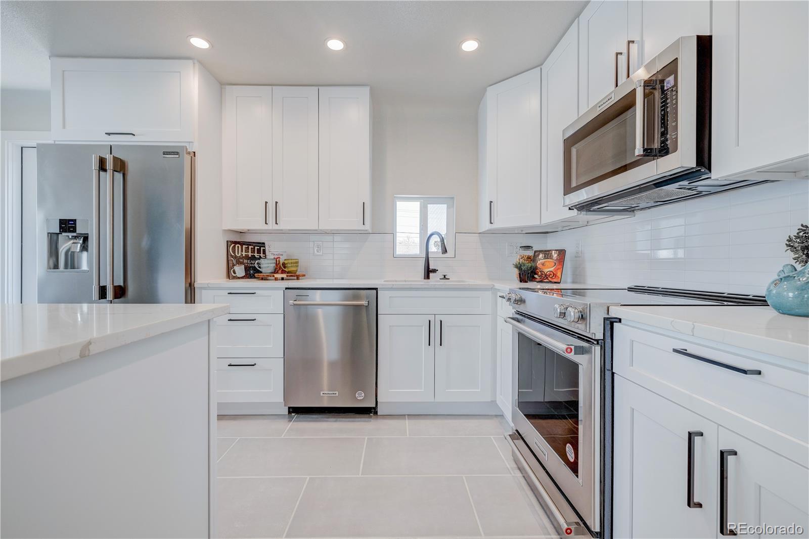 2932 Chase Street Wheat Ridge, CO 80214 - Photo 8 of 30 a kitchen with cabinets stainless steel appliances and sink