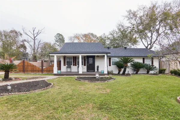 a front view of a house with a yard table and chairs