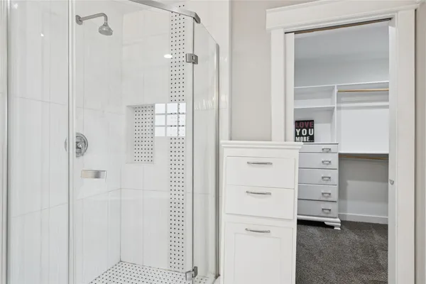 a view of walk in closet with clothes and shoes