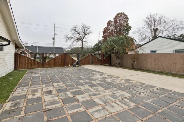 a front view of house with yard and trees around