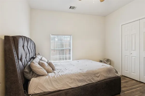 a bedroom with a bed and a dresser