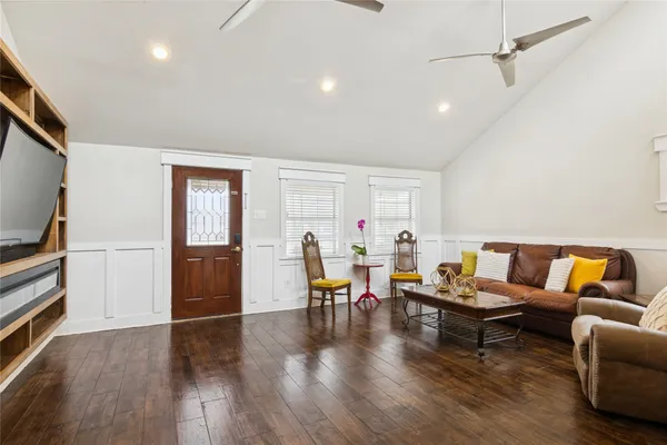 a living room with furniture and wooden floor