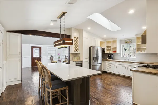 a kitchen with cabinets and window