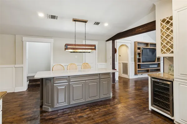 a dining room with furniture and wooden floor