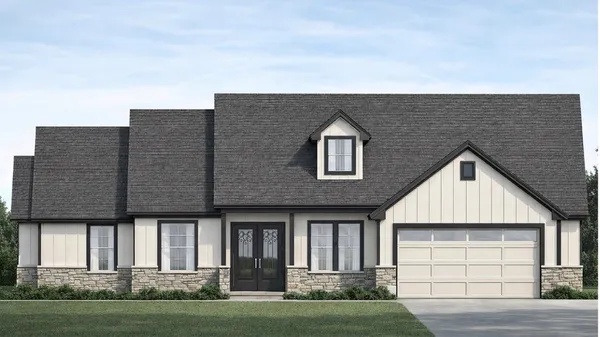 a front view of a house with a garden and yard