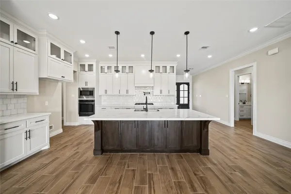 a large kitchen with stainless steel appliances lots of counter space sink and cabinets
