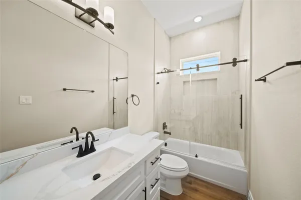 a bathroom with a sink toilet tub and shower