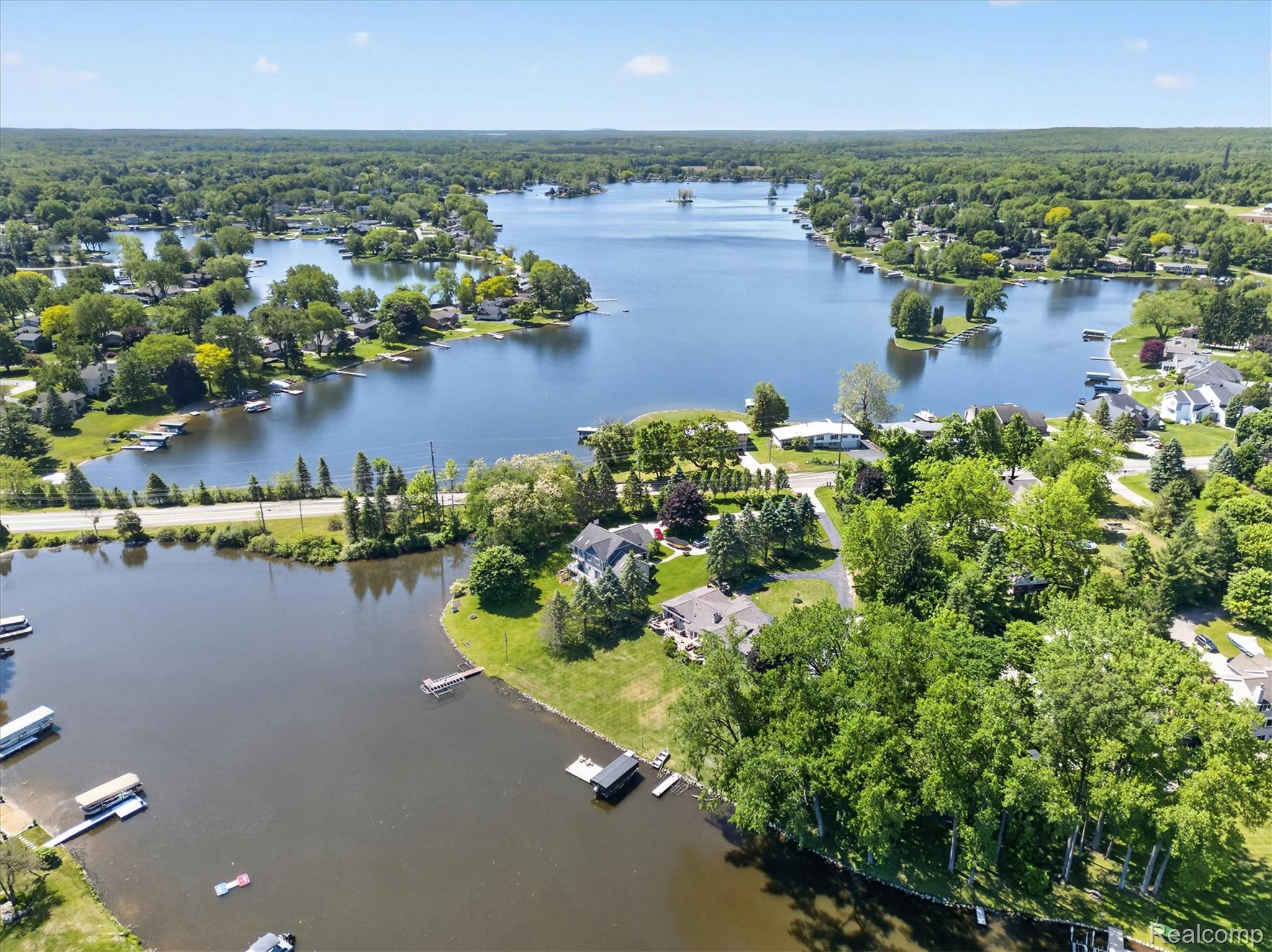 3860 East Commerce Road Commerce Township, MI 48382 - Photo 69 of 72 Expansive lakefront property featuring a private dock, mature tree coverage, and a paved road frontage