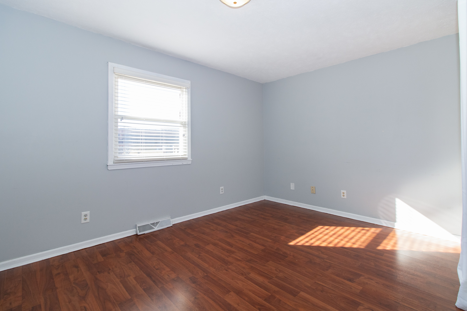 1705 Rockingham Drive, Unit 3 Normal, IL 61761 - Photo 12 of 31 an empty room with wooden floor and windows