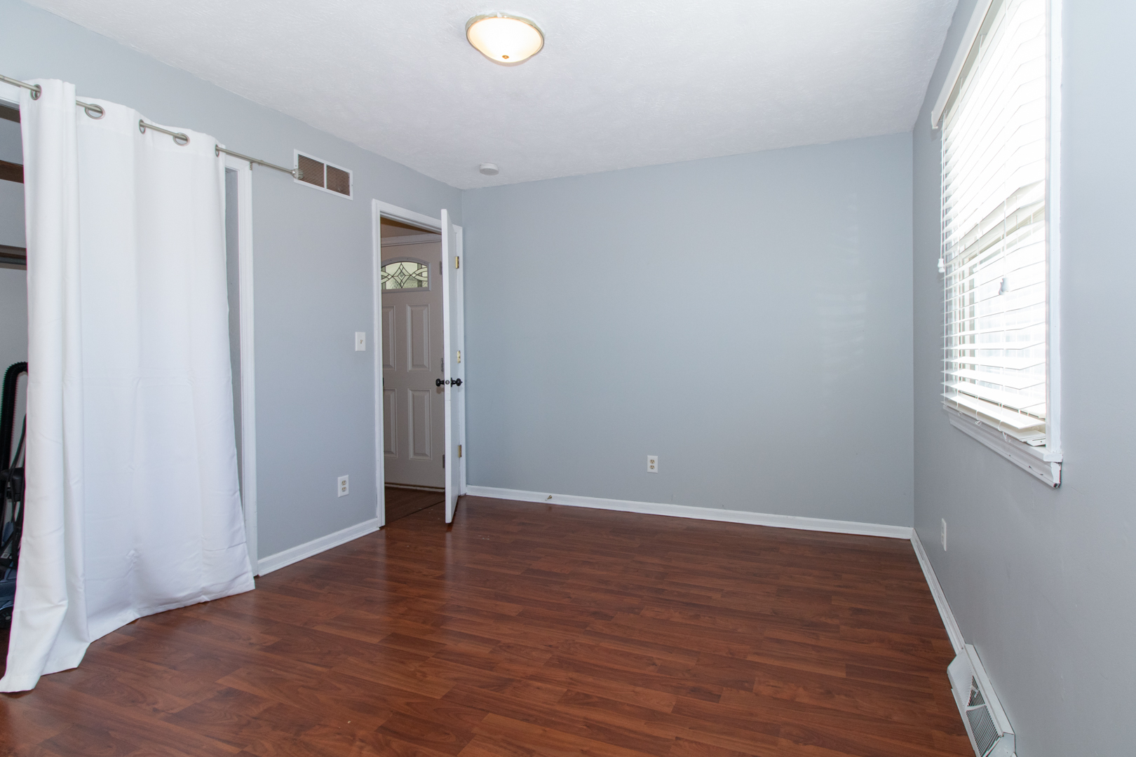 1705 Rockingham Drive, Unit 3 Normal, IL 61761 - Photo 15 of 31 a view of an empty room with wooden floor and a window