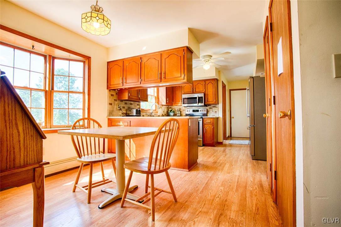 187 Nolf Road Nazareth, PA 18064 - Photo 5 of 33 a view of a dining room with furniture a chandelier and wooden floor