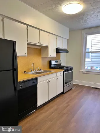a kitchen with stainless steel appliances a refrigerator sink and cabinets