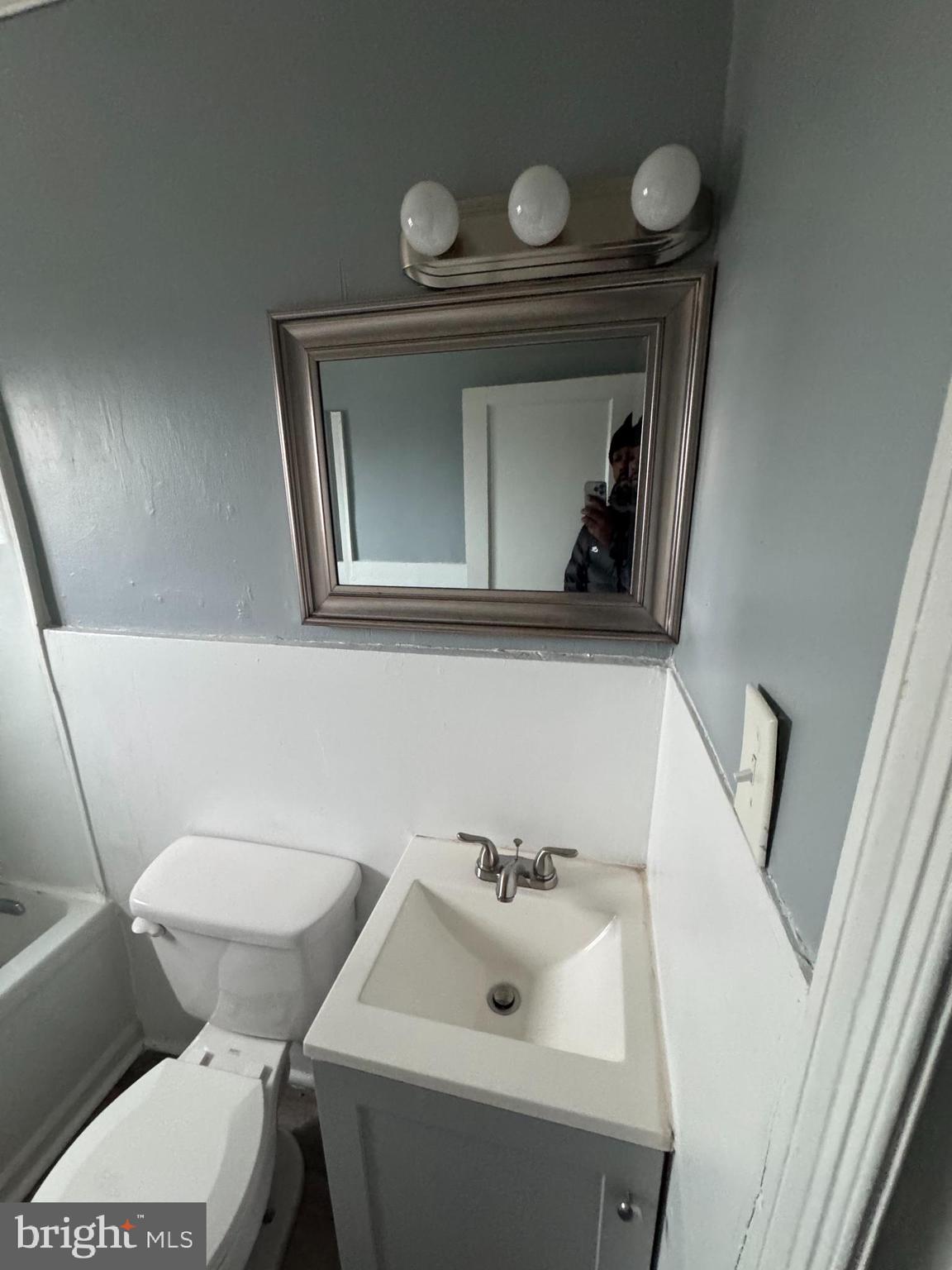 418 Stemmers Run Road Essex, MD 21221 - Photo 14 of 23 a bathroom with a toilet sink and mirror