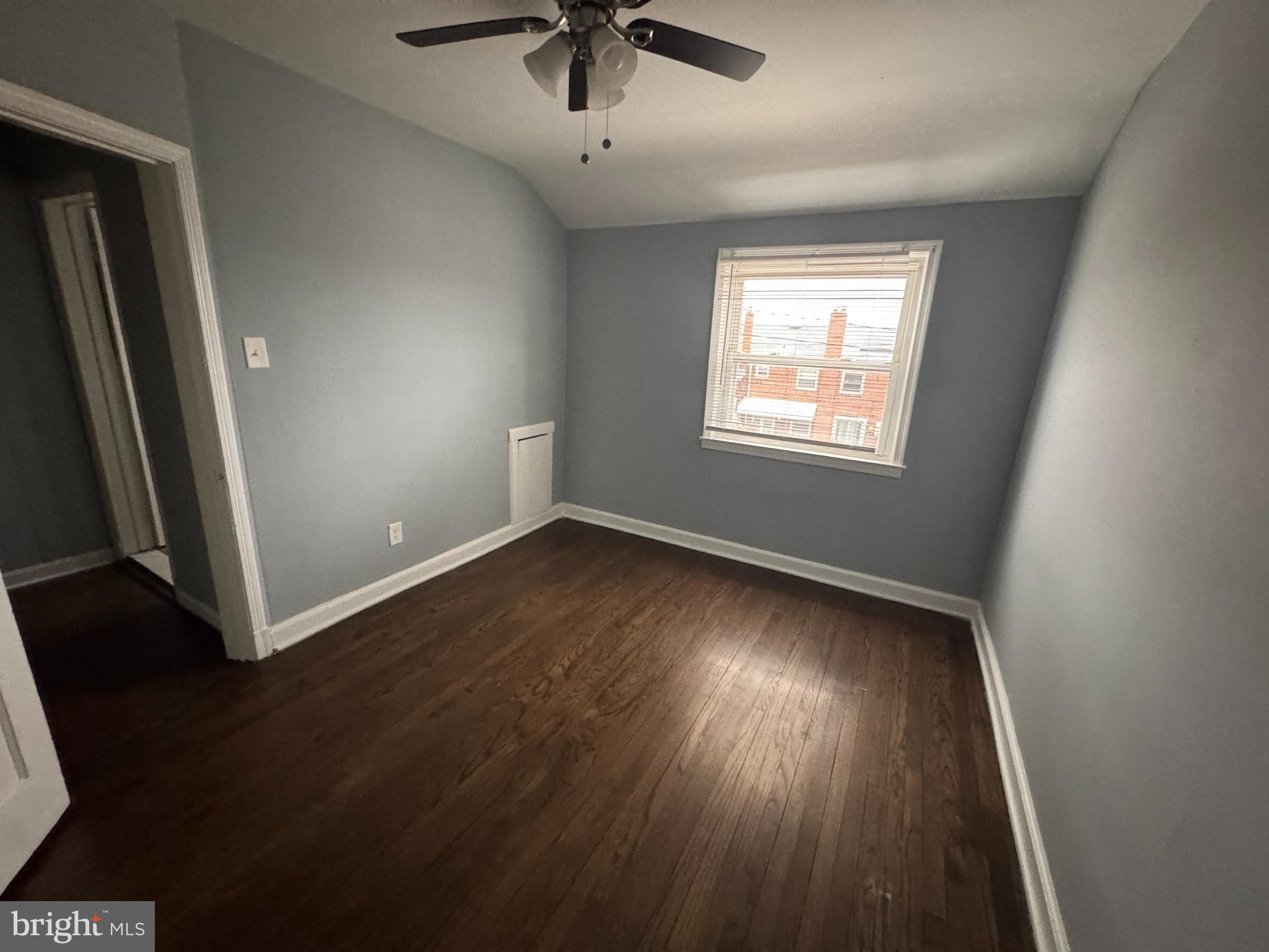 418 Stemmers Run Road Essex, MD 21221 - Photo 17 of 23 an empty room with wooden floor fan and windows