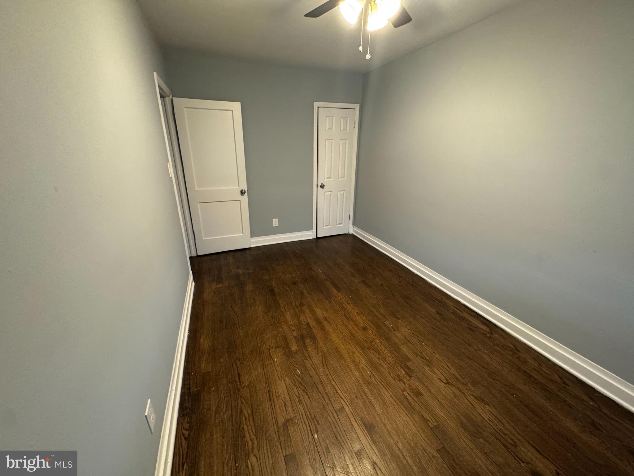 418 Stemmers Run Road Essex, MD 21221 - Photo 19 of 23 an empty room with wooden floor and windows