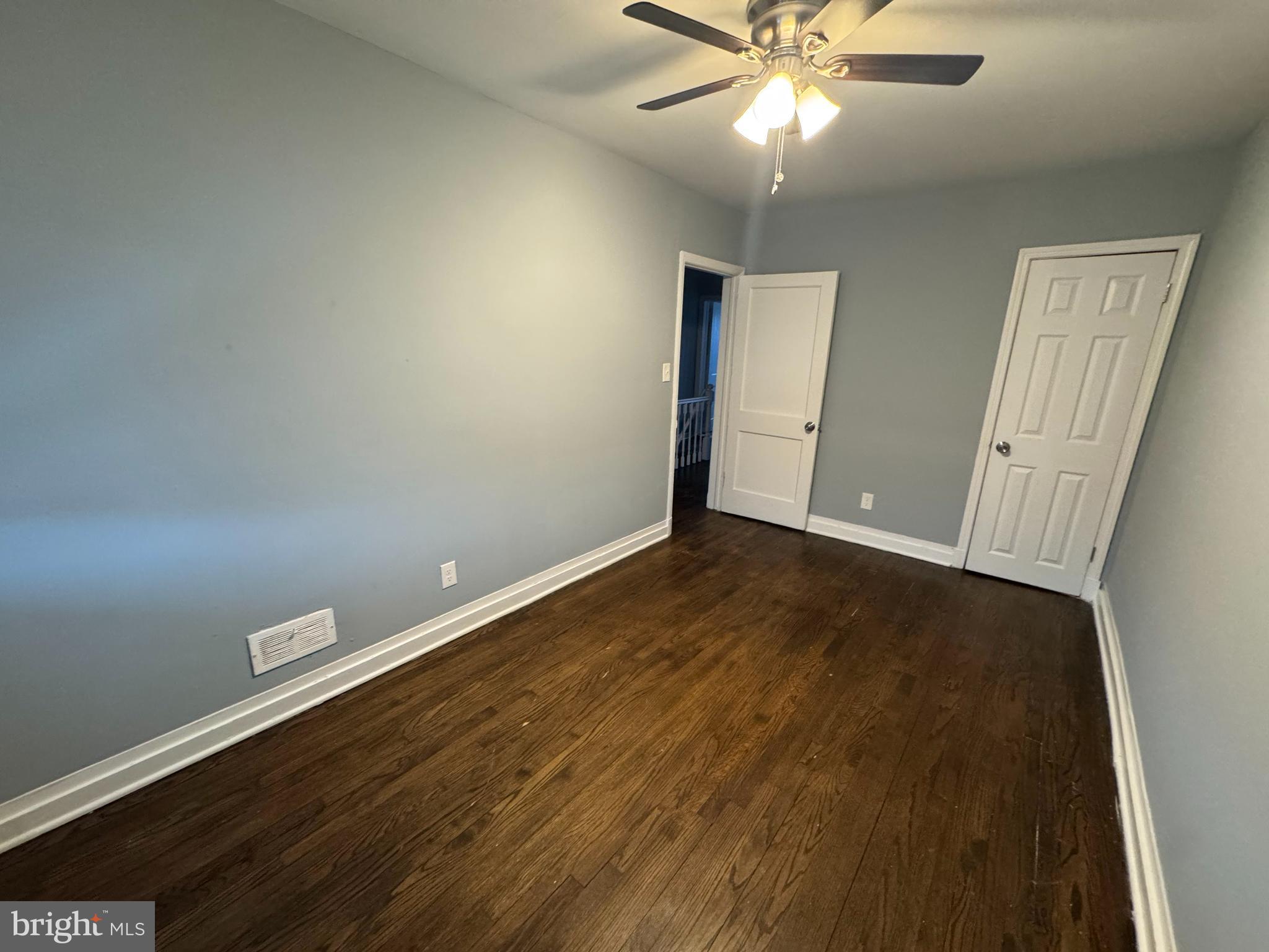 418 Stemmers Run Road Essex, MD 21221 - Photo 20 of 23 an empty room with wooden floor fan and window