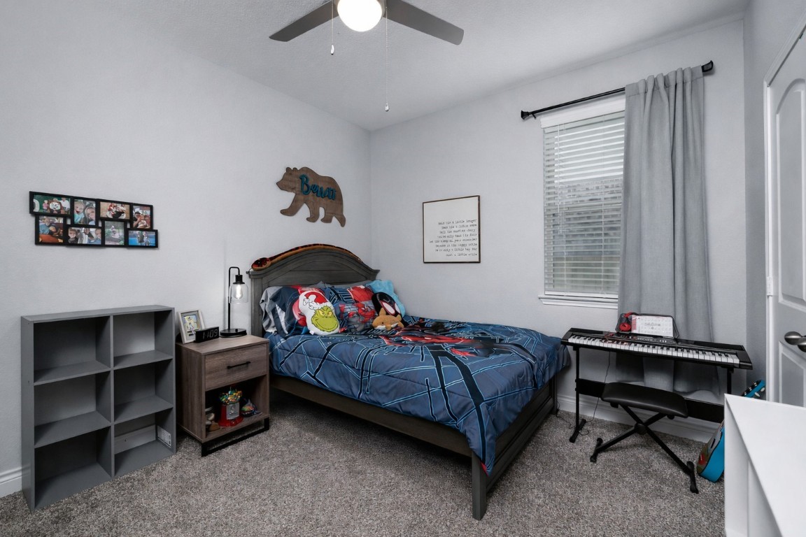 1507 Oakdale Crest Road Montgomery, TX 77316 - Photo 19 of 23 a bedroom with a bed and a chandelier