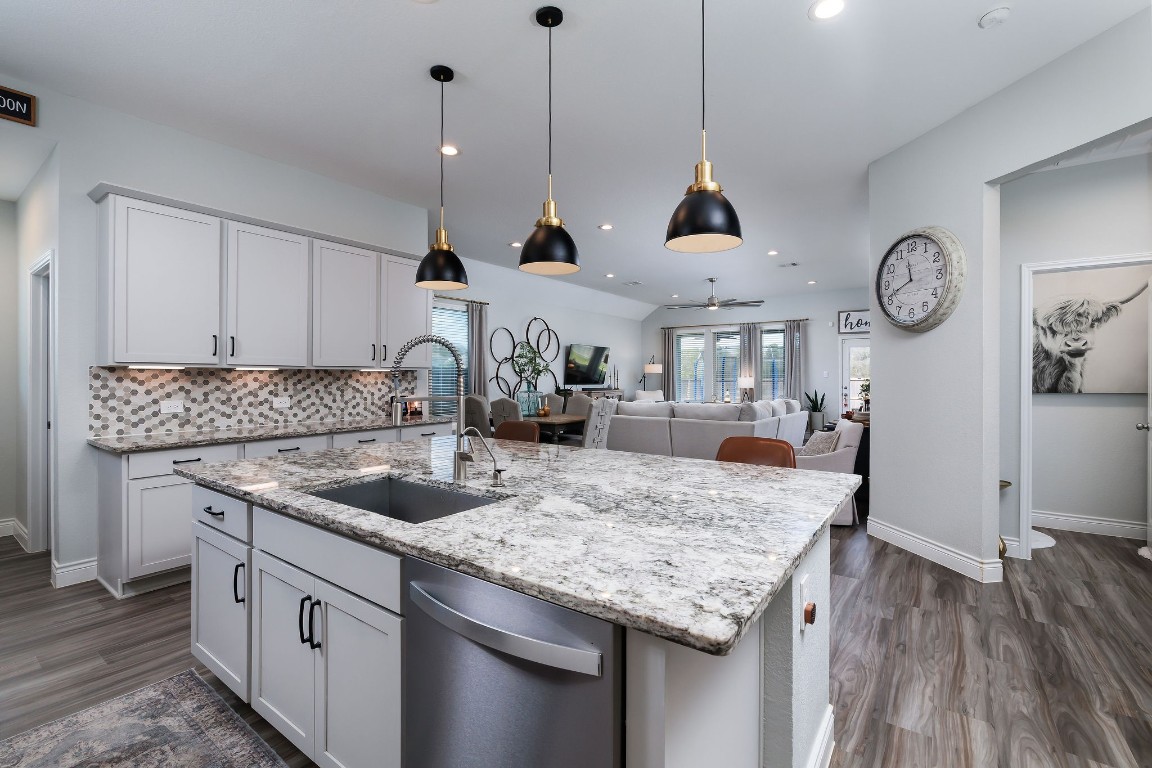 1507 Oakdale Crest Road Montgomery, TX 77316 - Photo 2 of 23 a kitchen with granite countertop cabinets a sink a window and stainless steel appliances