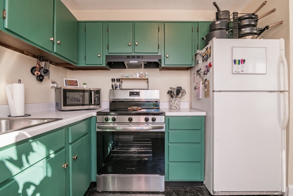 244 Nassau Drive, Unit 244 Springfield, MA 01129 - Photo 11 of 17 a kitchen with a refrigerator a stove and washer