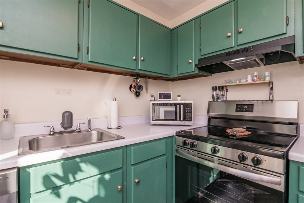 244 Nassau Drive, Unit 244 Springfield, MA 01129 - Photo 12 of 17 a kitchen with stainless steel appliances granite countertop a sink and cabinets