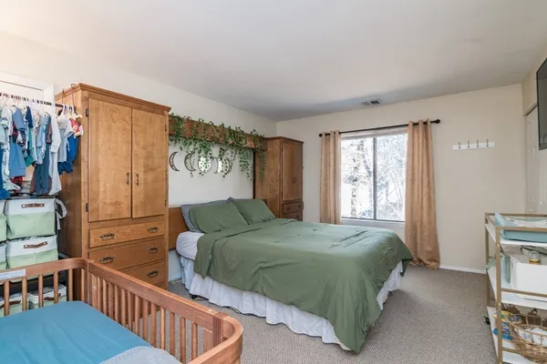 a bedroom with a bed and flat screen tv