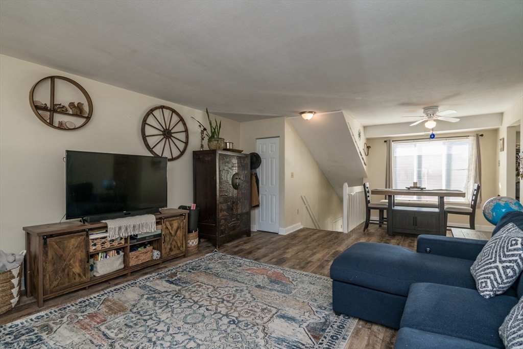 244 Nassau Drive, Unit 244 Springfield, MA 01129 - Photo 5 of 17 a living room with furniture and a flat screen tv