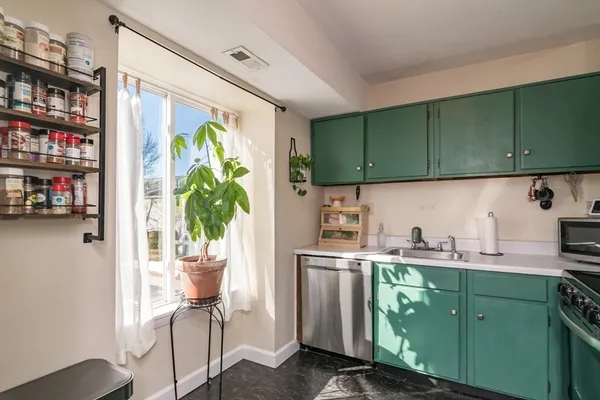 a kitchen with a refrigerator a sink and a cabinets