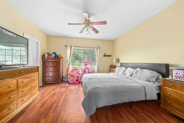 a bedroom with a bed and wooden floor